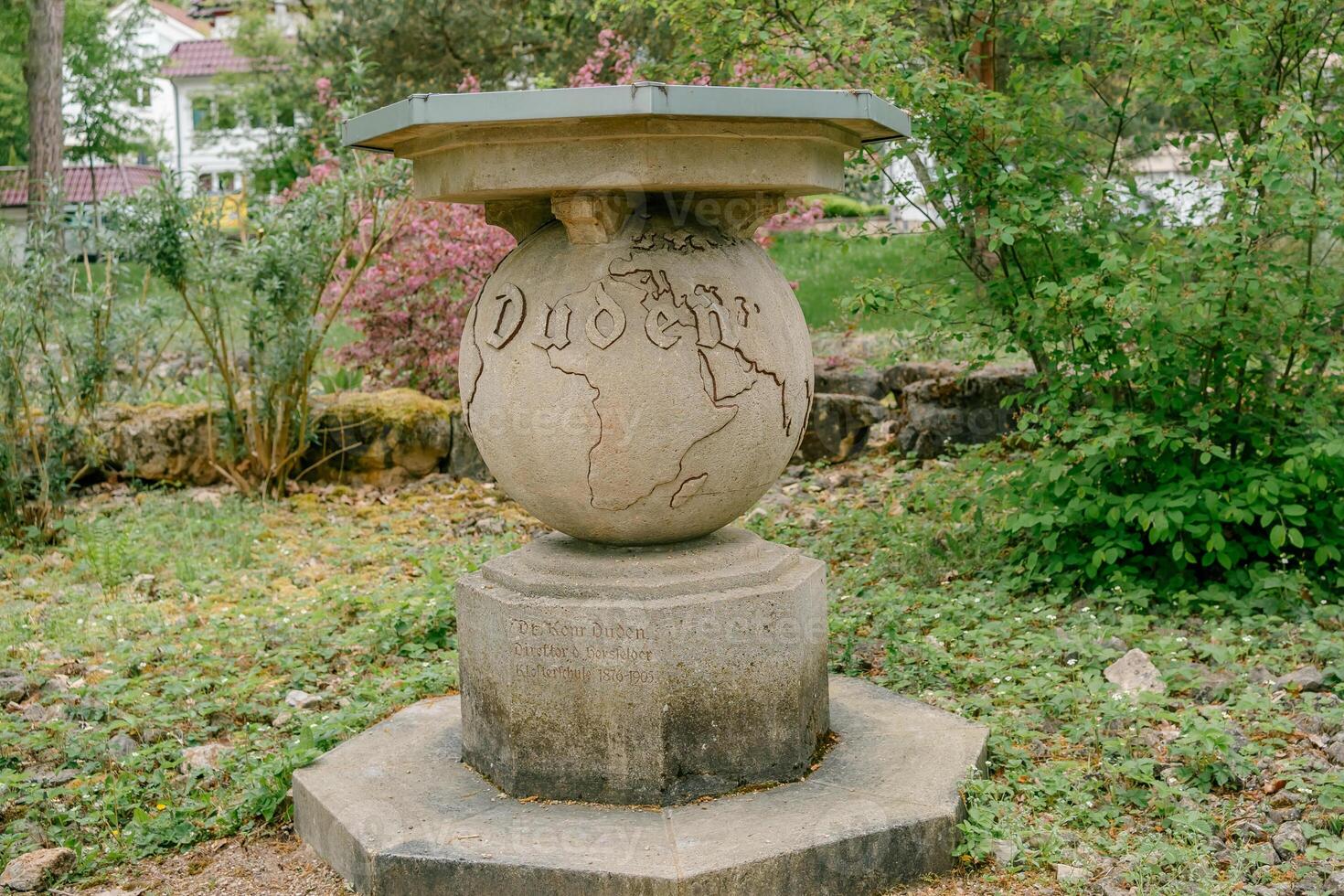 Stone Monument with World Map and Duden Text photo