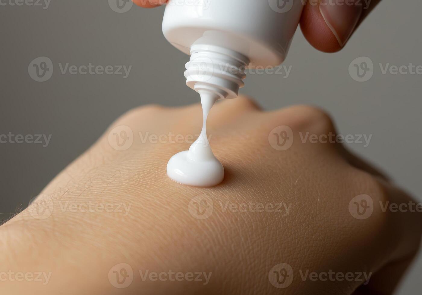 Moisturizing cream being applied on hand in a close up view during skincare routine photo