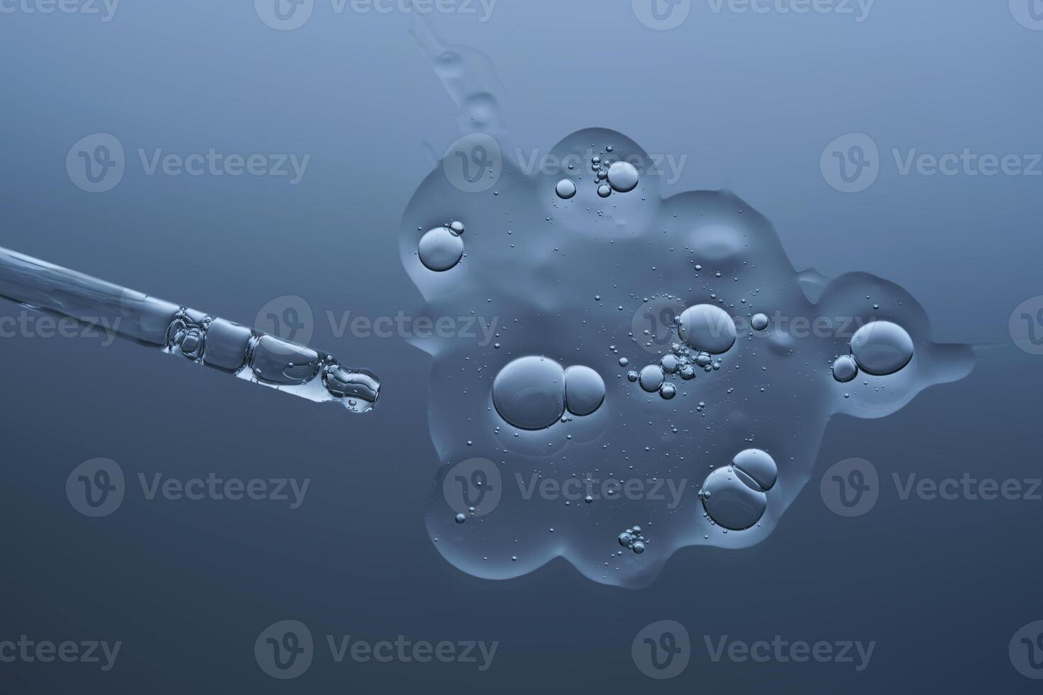 The texture of the hyaluronic serum and cosmetic pipette on a beautiful gray-blue background. photo