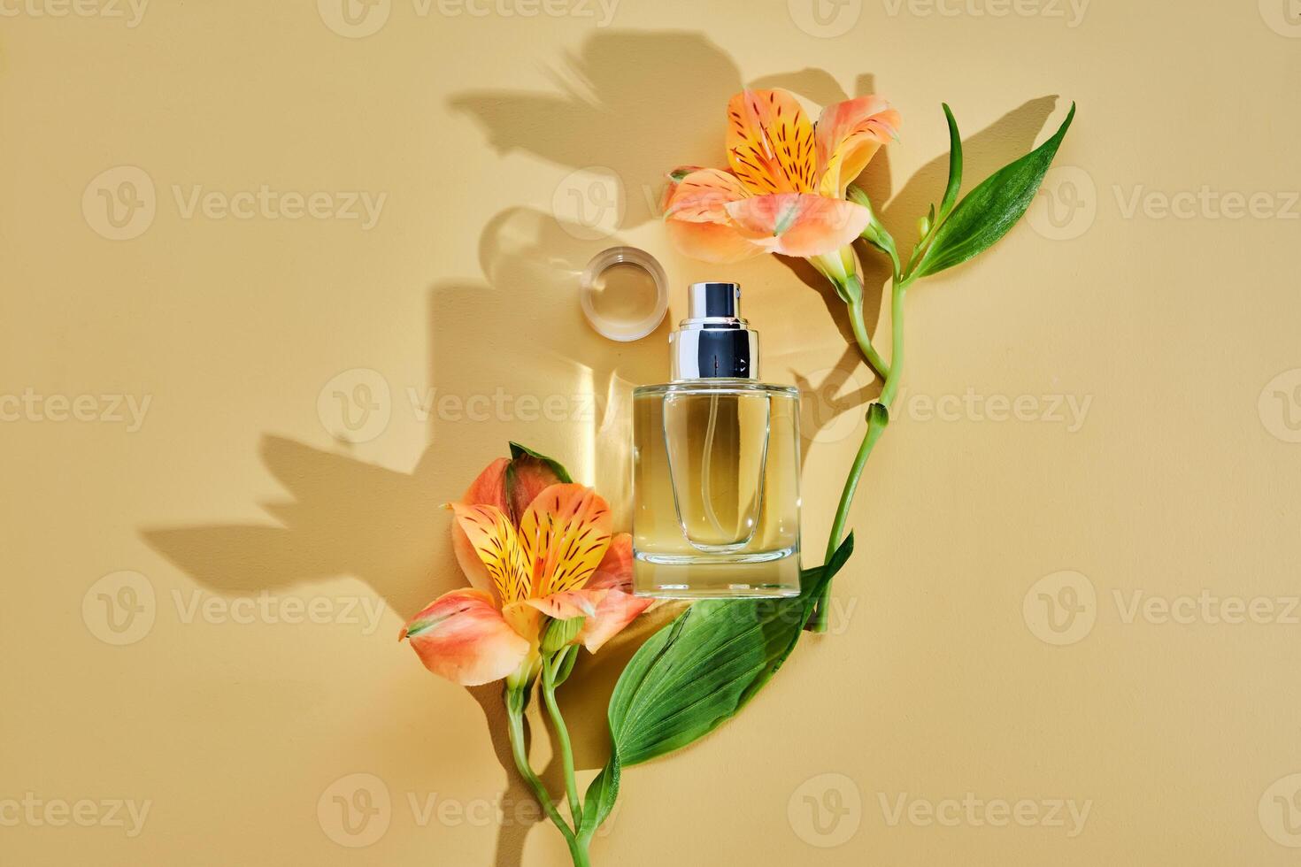Mist for hair or perfume on a beige background with lily flowers. photo
