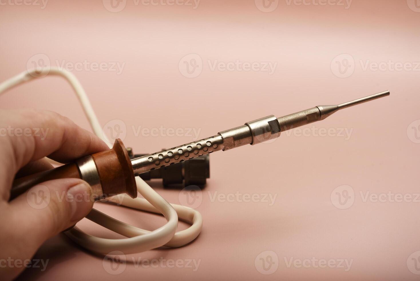 A traditional soldering iron with a silver-plated tip photo