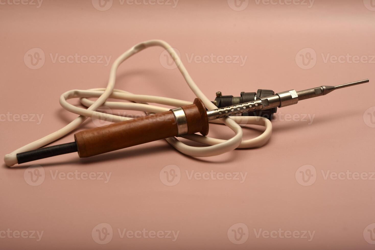 An aged soldering implement with a silver-plated point photo