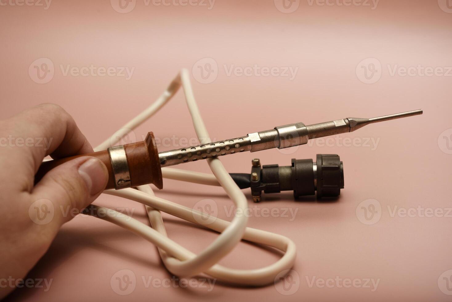 An ancient soldering implement displaying a silver tip photo