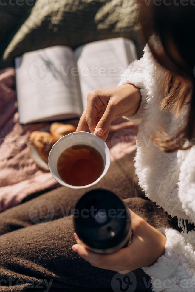 fluffy textures sunlight and natural tones Cozy Tea Time with Book and Pastries relaxed autumn lifestyle composition photo