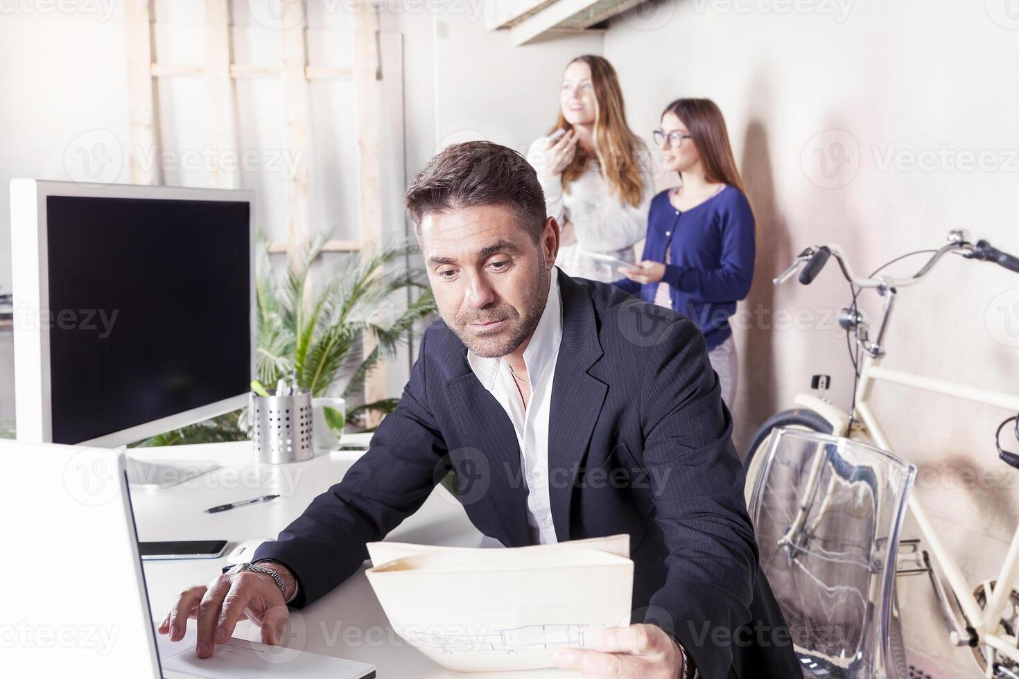 young business man working on laptop on office desk photo