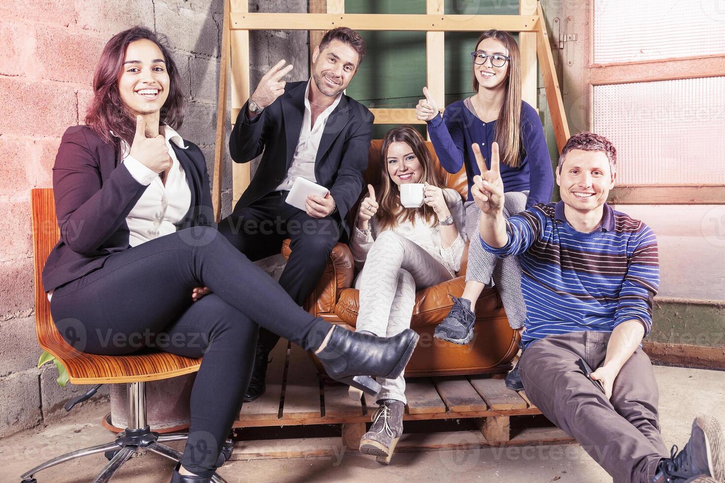 a group of young business people showing the peace sign a moment of relaxation indoors photo