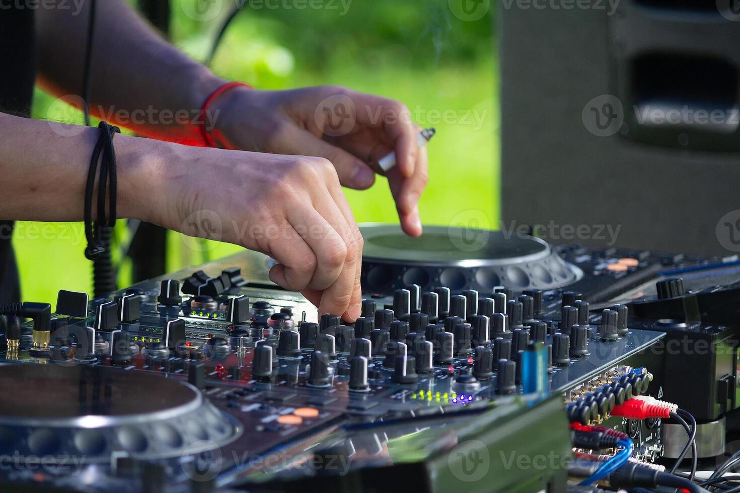 DJ Hands creating and regulating music on dj console mixer in concert outdoor photo