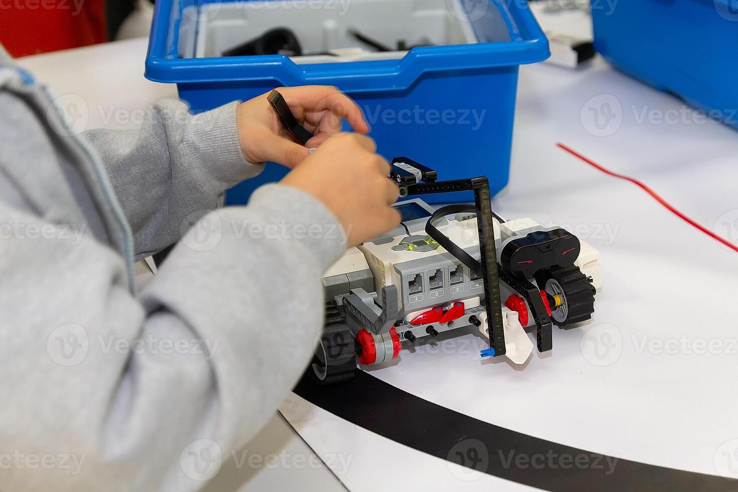 Children are working on model assembly in robotics class photo
