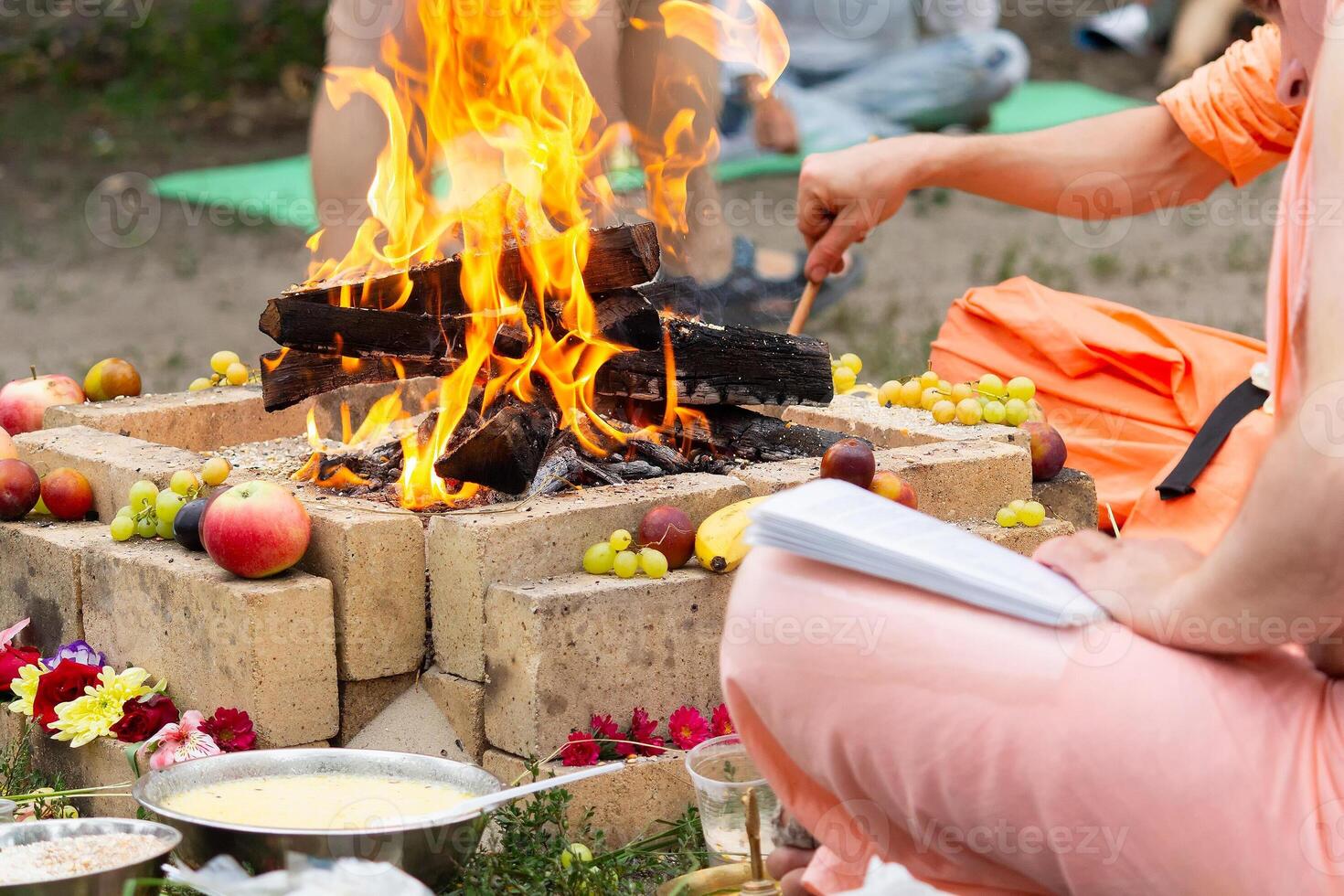 Hindu ritual with cooking and prayer reading photo