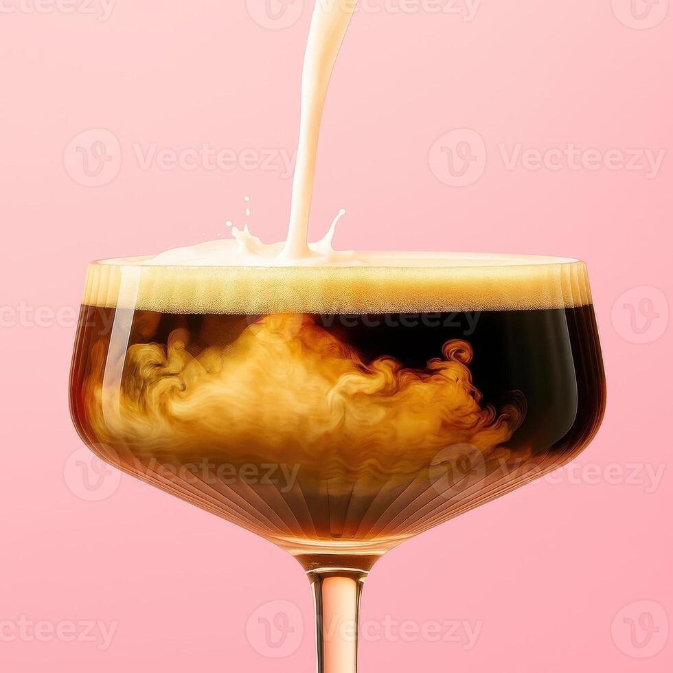 A low cocktail glass with a stem filled with dark coffee liqueur, as thick cream is poured into it from above. photo