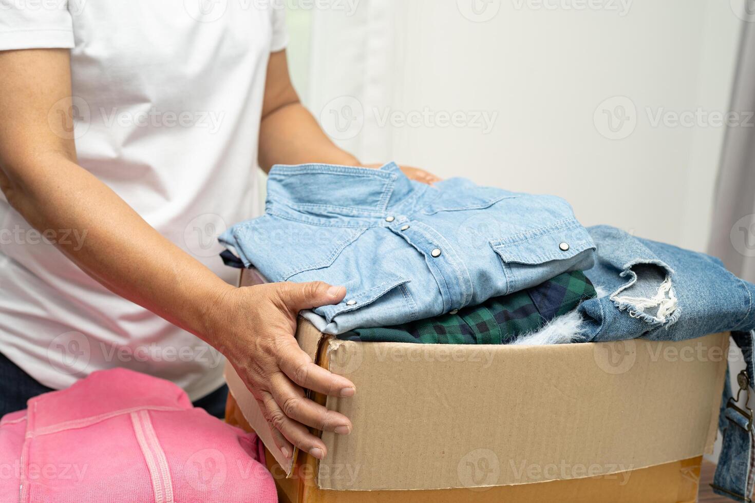 Donation box with used clothes at home to support help for poor photo