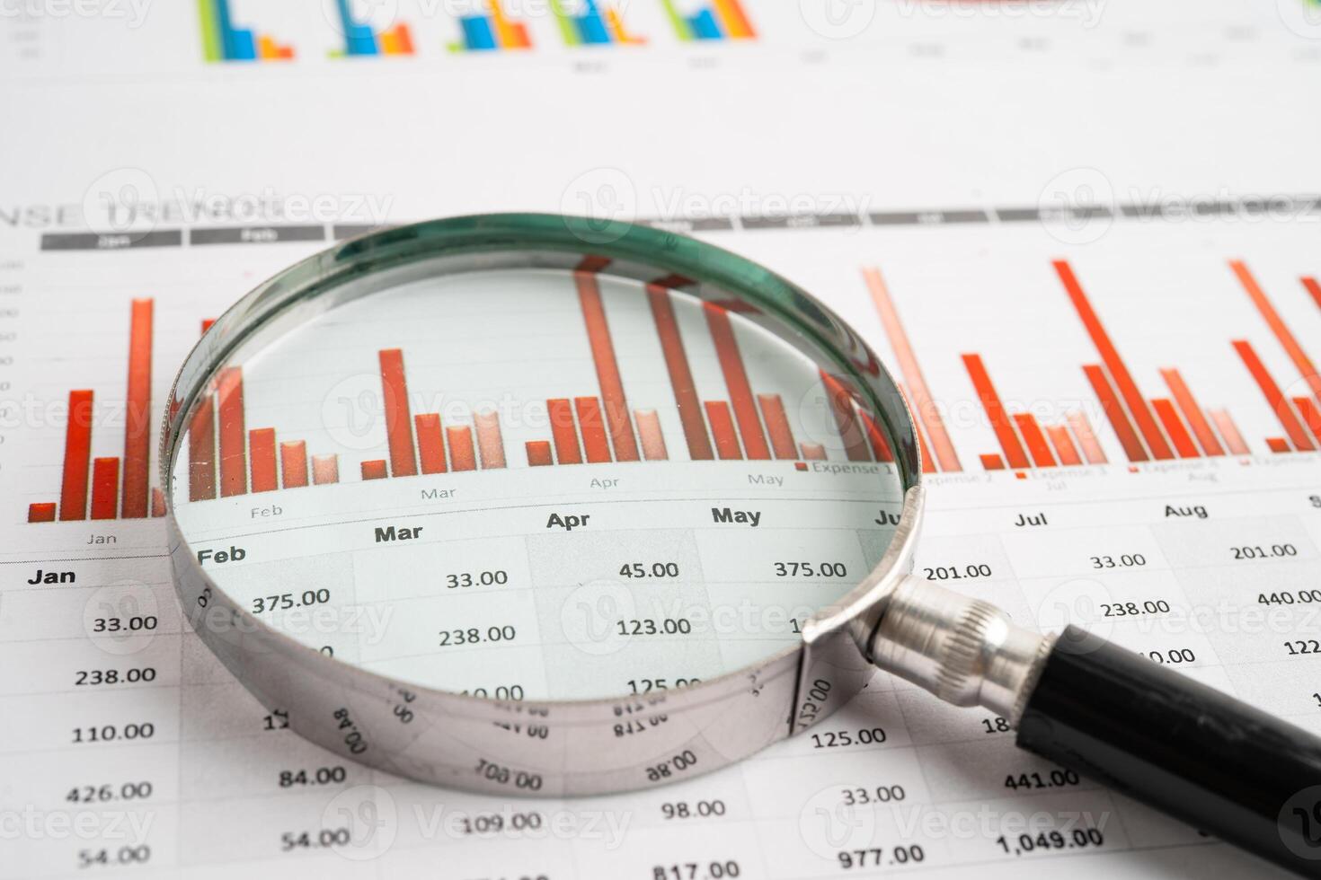 Magnifying glass on spreadsheet and graph paper. Financial data economy, Business. photo