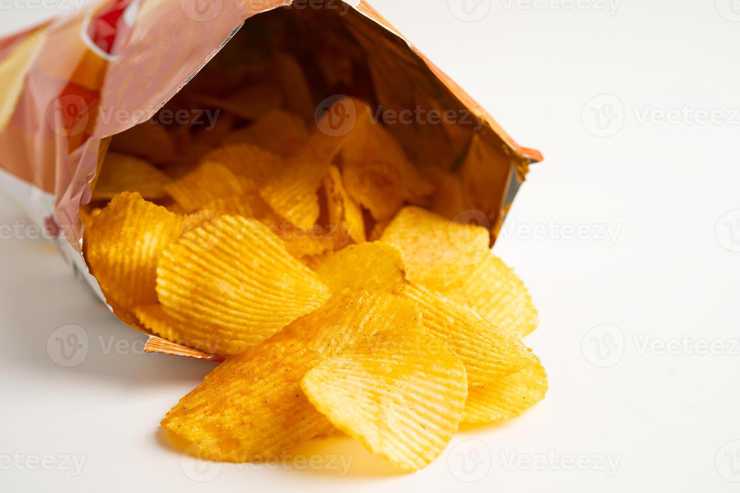 Potato chips delicious BBQ seasoning spicy for crips, thin slice deep fried snack fast food in open bag. photo
