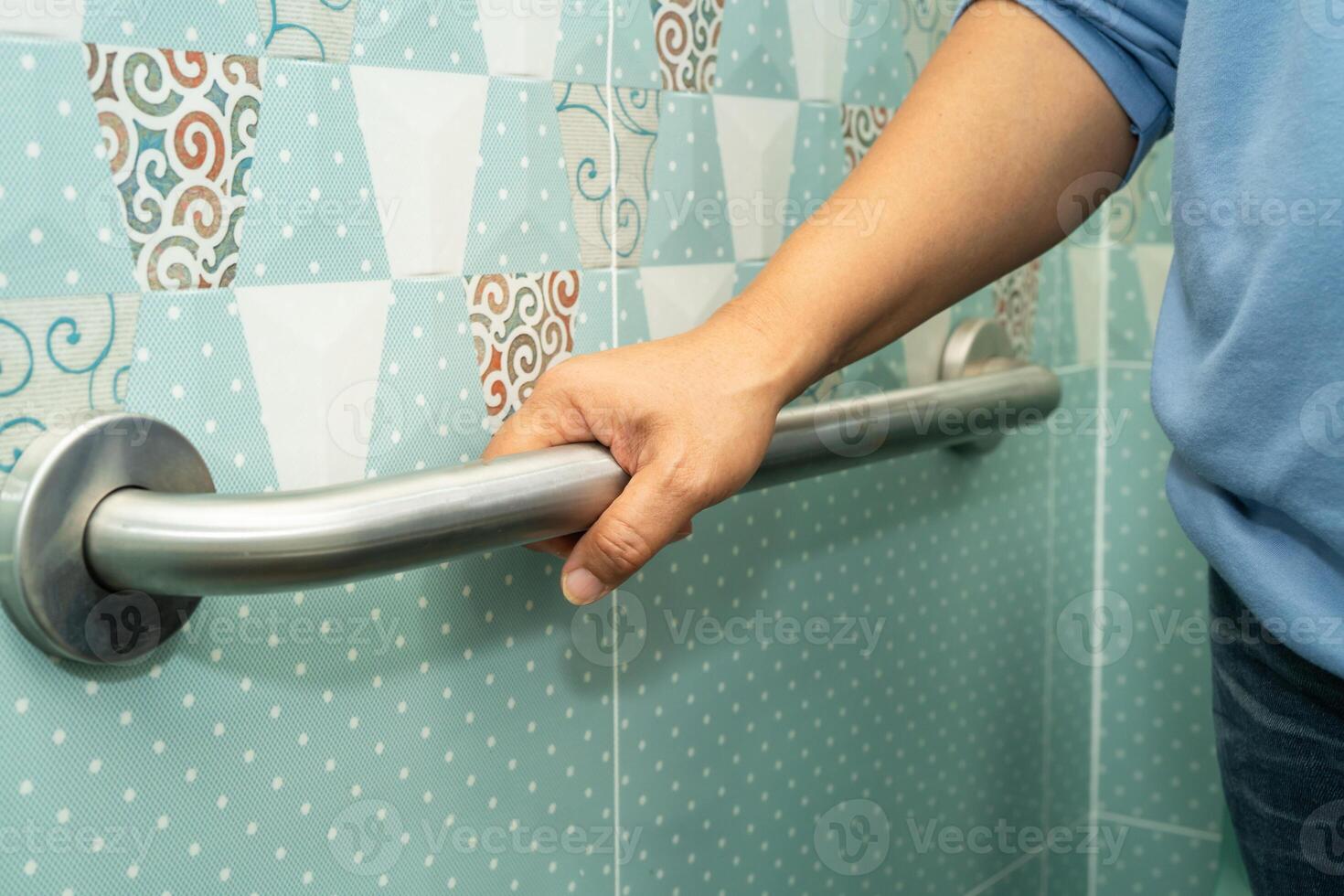 elderly woman patient use toilet bathroom handle security in nursing hospital, healthy strong medical. photo