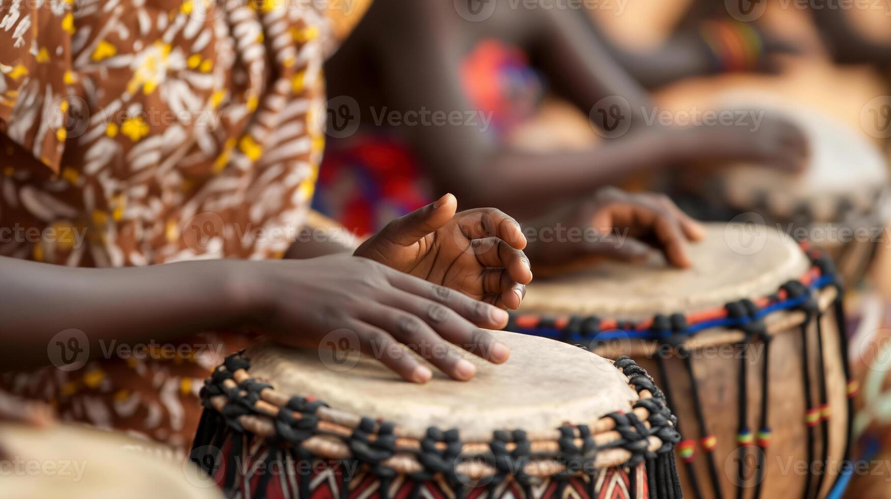 A close up detail of an African child playing a traditional djembe drum. photo