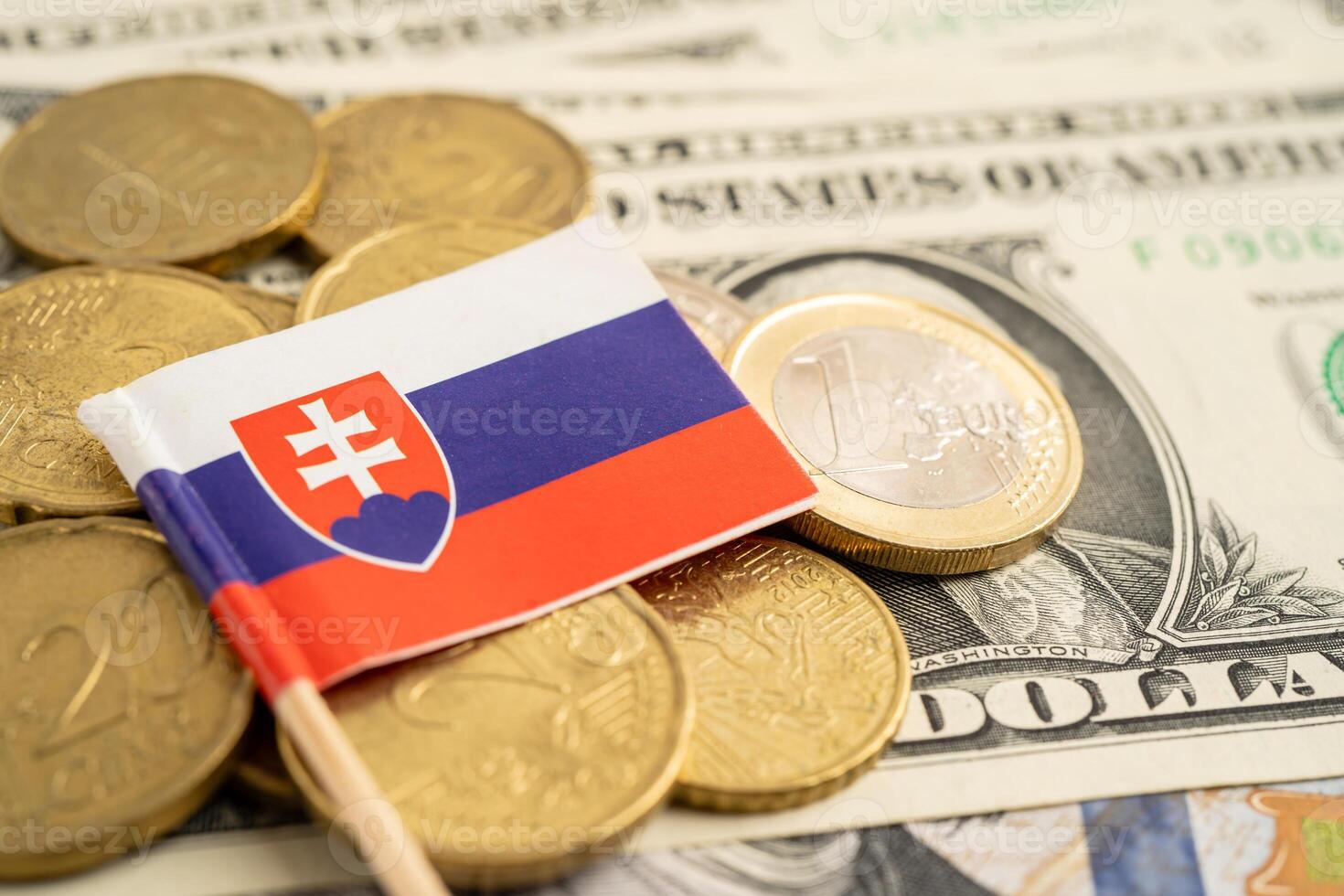 Stack of coins with Slovakia flag and US dollar banknotes. photo