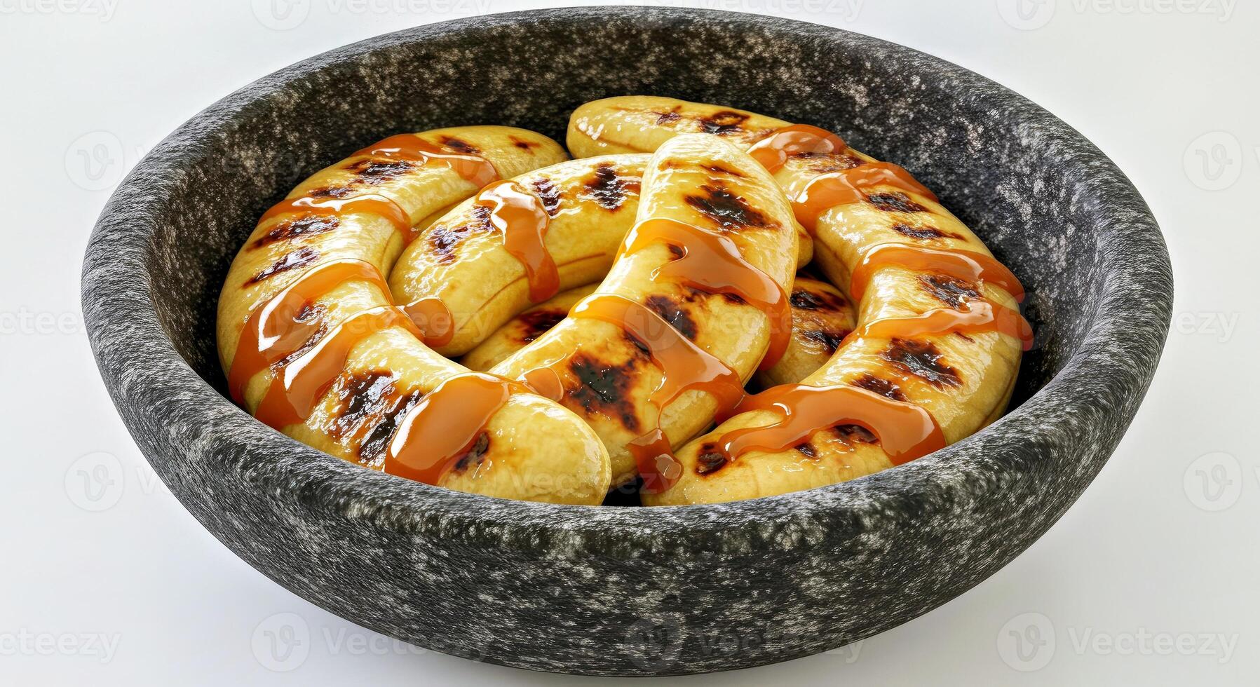Close Up View of Delicious Grilled Banana with Caramel Sauce in a Dark Bowl photo