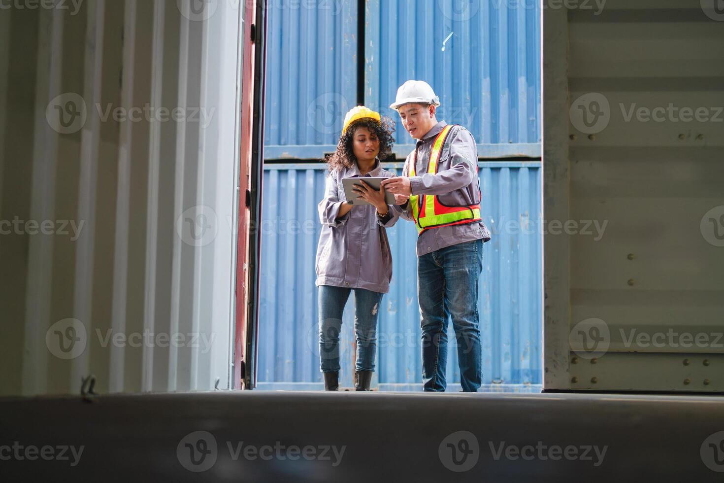 Engineer and Foreman Team in Safety Gear Inspecting Containers Box at Industrial Site, Container Yard Dock Workers Discussion at Shipping Yard photo
