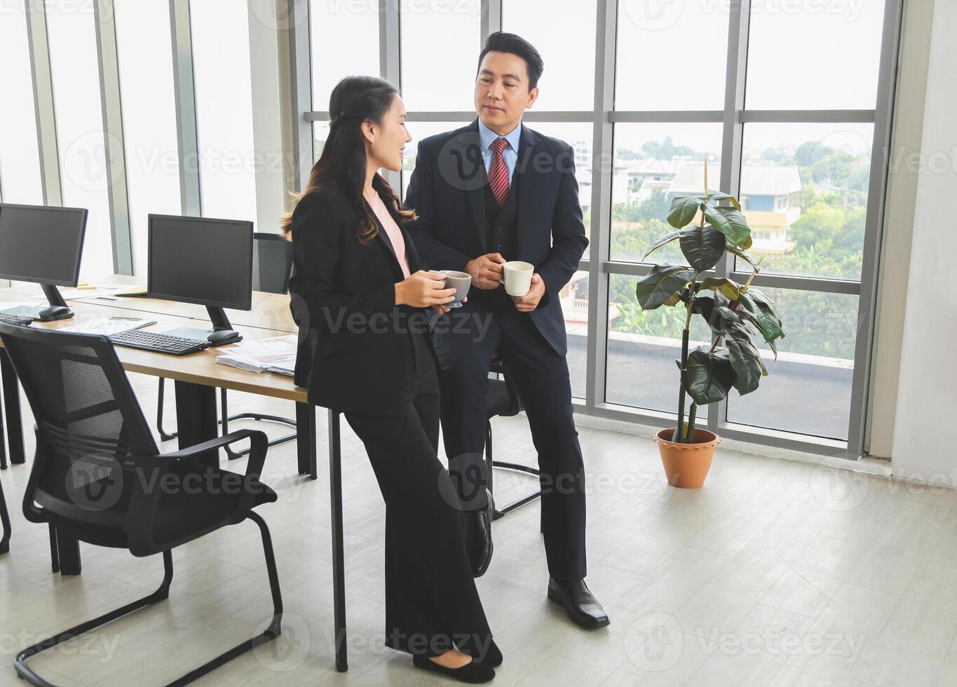 Business Colleagues Enjoying Coffee Break in Modern Office, Professional Team Chatting During Work Break, Friendly Conversation Between Coworkers in Office Setting photo