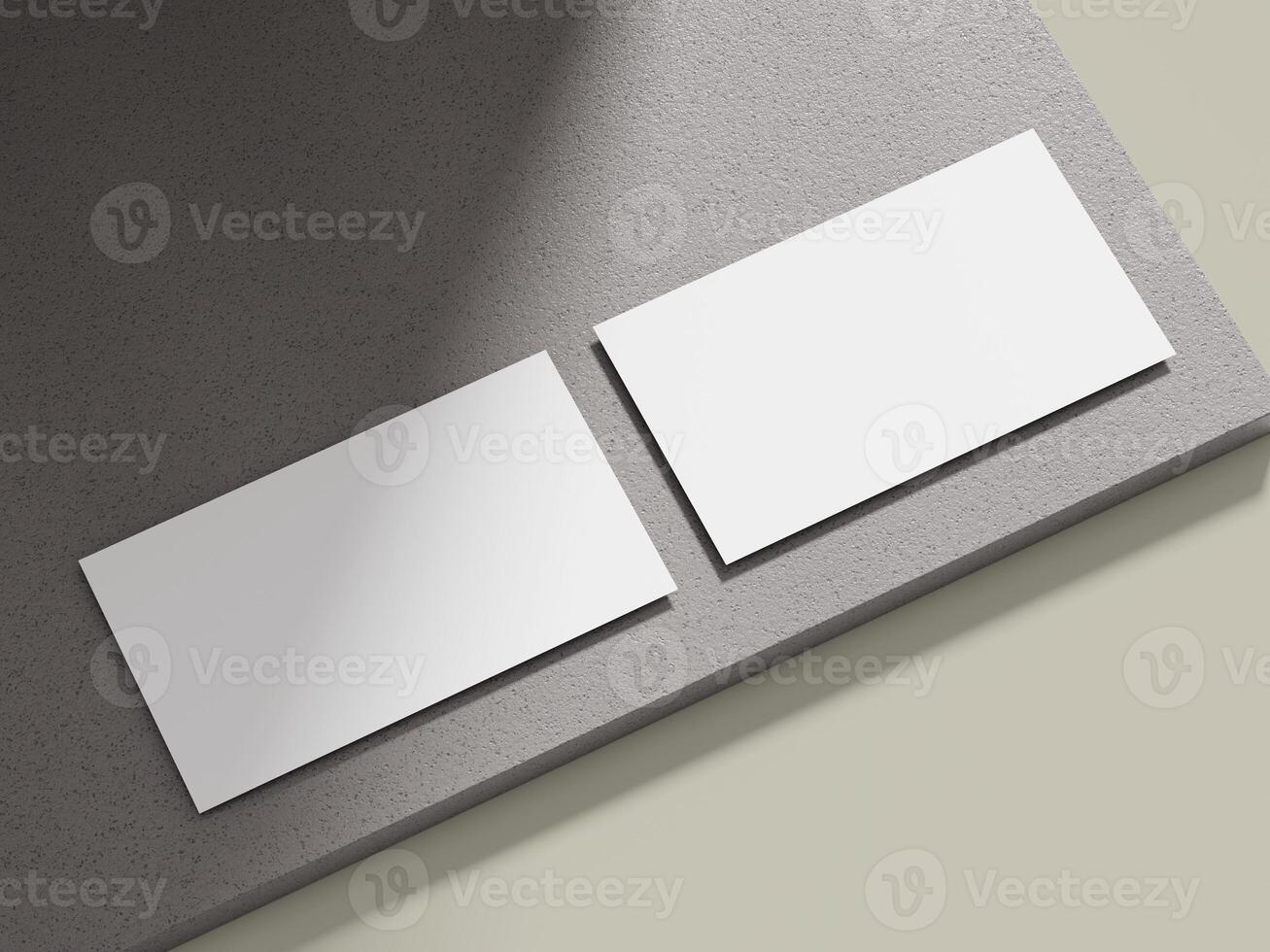 Business card mockup positioned on a light grey cement block with clean lines, suitable for showcasing corporate identity. photo