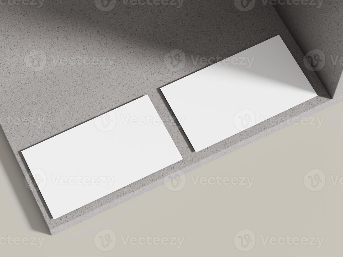 A business card mockup resting on a light neutral cement surface with minimal shadows, ideal for clean and simple designs. photo