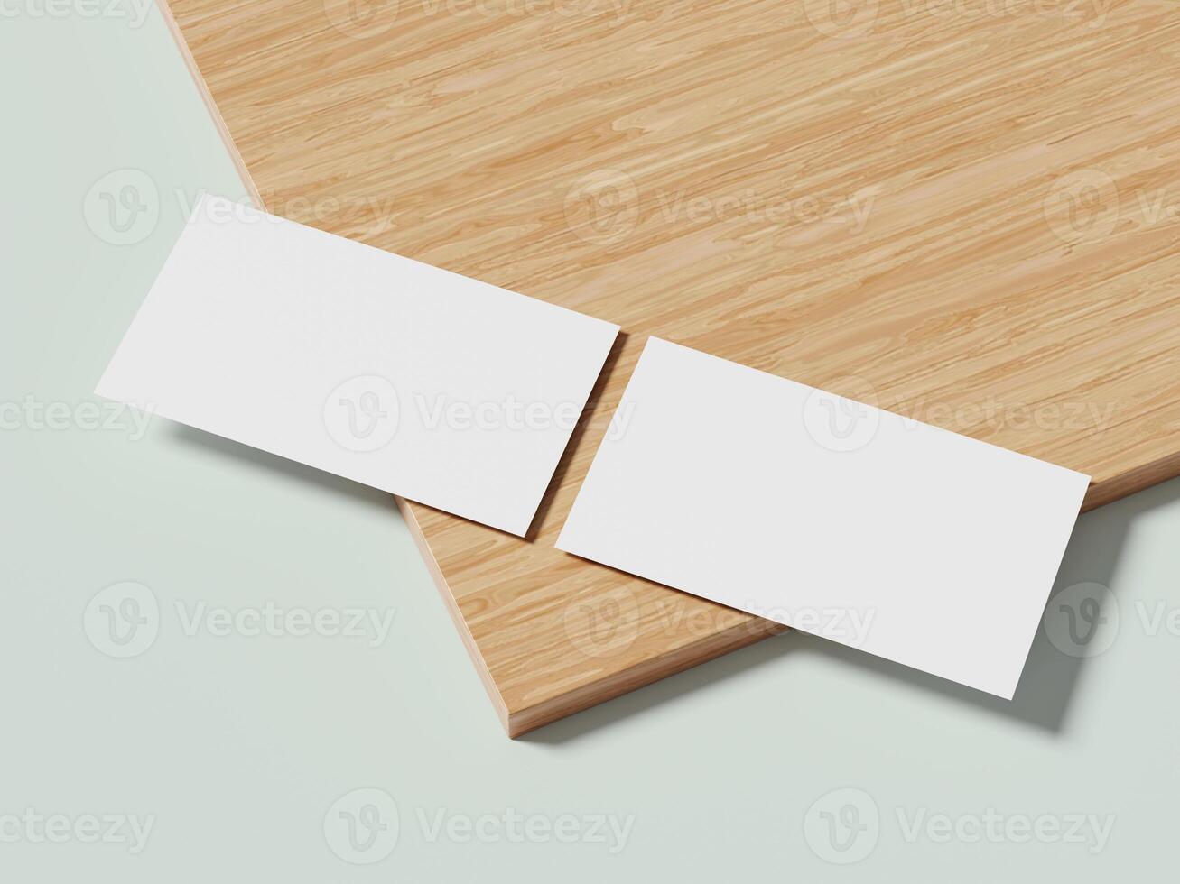 Two white business cards arranged neatly on a wooden surface, their clean design contrasting with the natural texture of the wood. photo