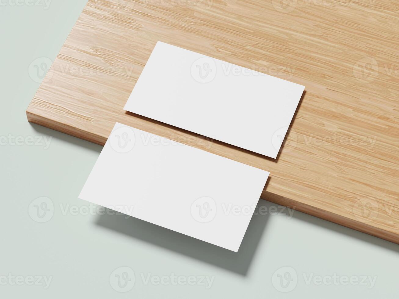 A pair of white business cards on a wooden surface, subtly angled to create an elegant and modern visual effect. photo
