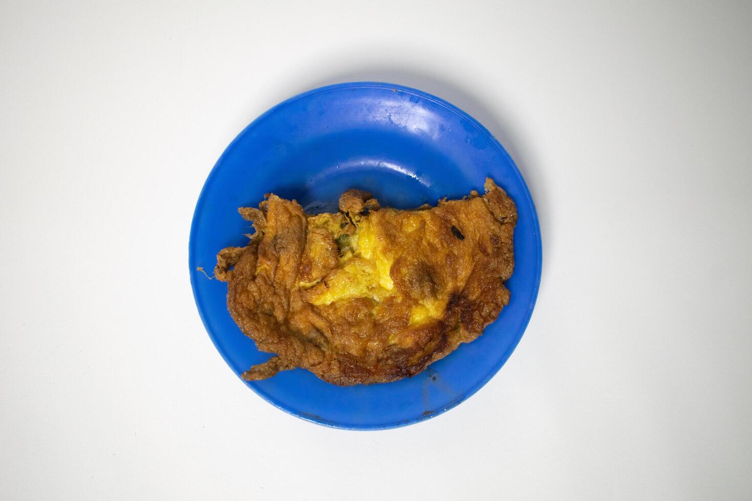 Omelette, fried on a blue plate. photo