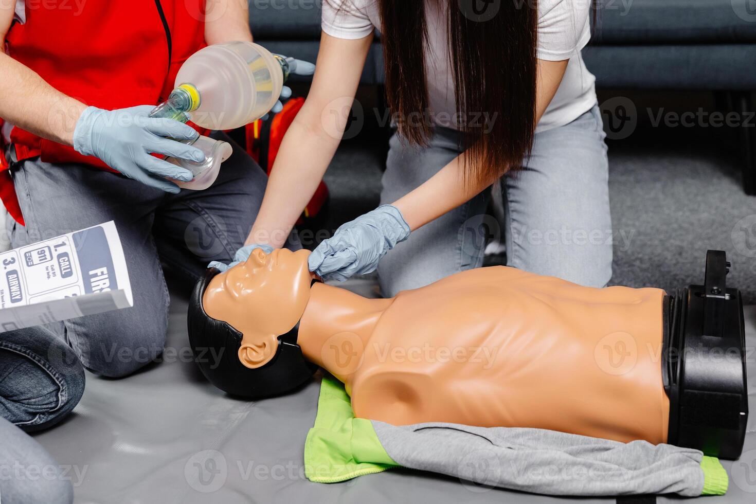 Woman holding breathing bag Ambu bag.Demonstrating CPR Cardiopulmonary resuscitation training medical procedure on CPR doll in the class.Paramedic demonstrate first aid practice for save life. photo