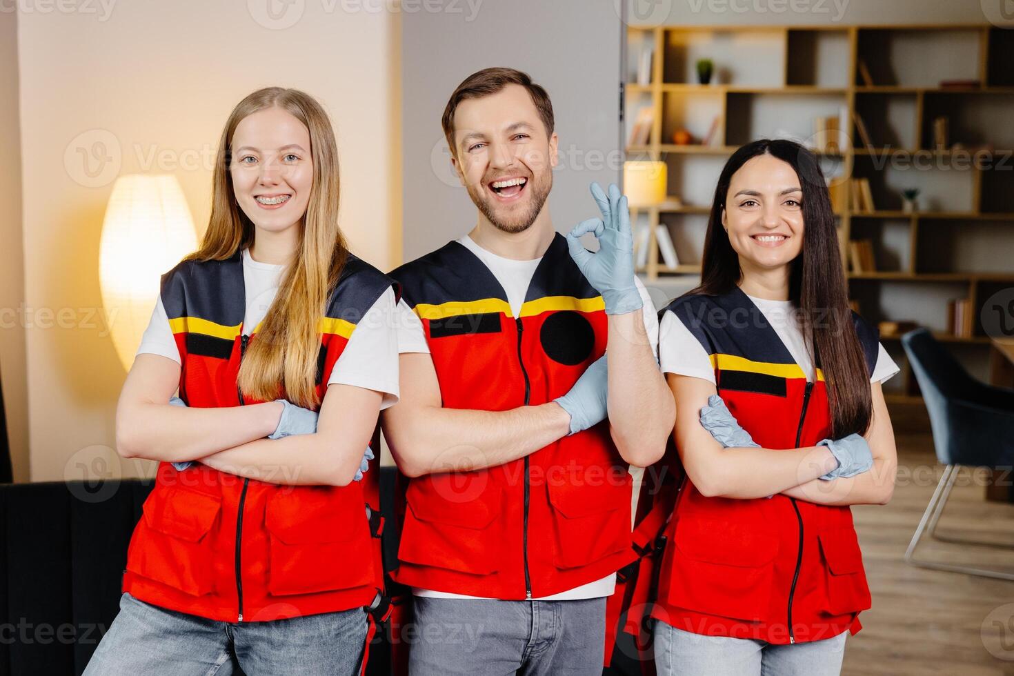 Group of people with cpr dummy looking at camera and smiling after first aid training photo
