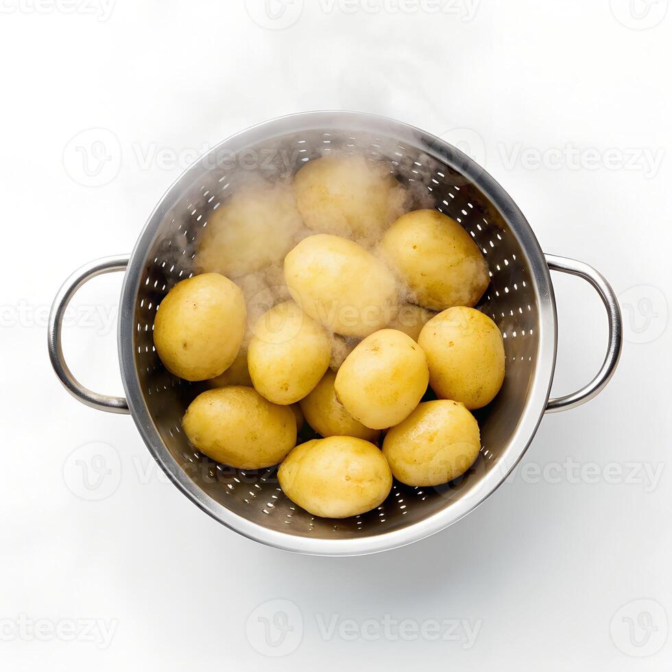 Steaming Boiled Potatoes in Metal Strainer on White photo