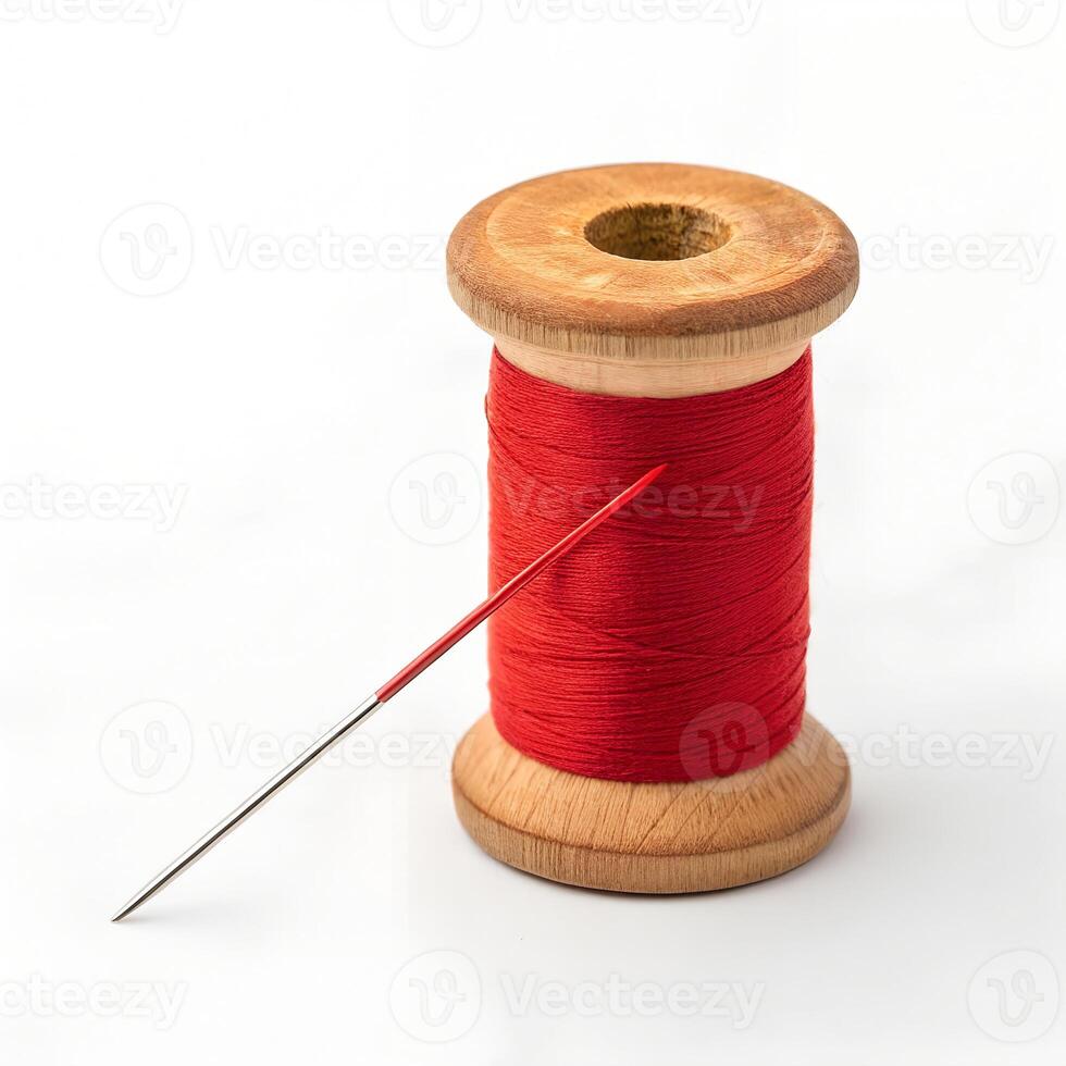 Wooden Spool with Bright Red Sewing Thread and Needle photo
