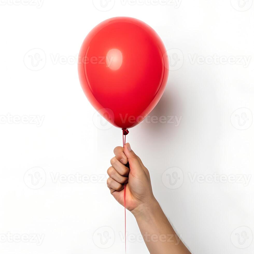 A vibrant red balloon, held gently against a plain background, suggests celebration, joy, and a sense of wonder. photo