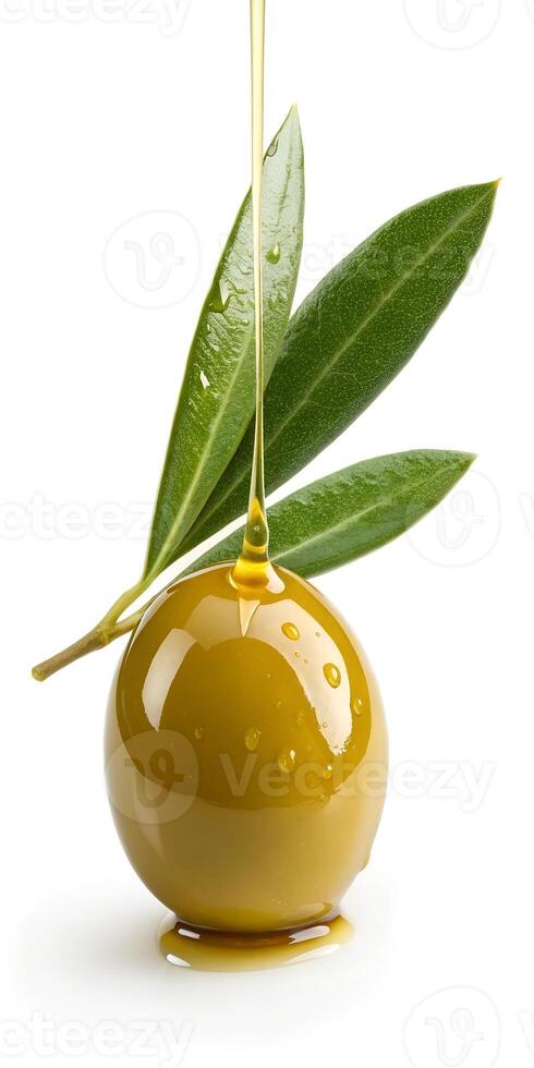 Green Olive with a Drip of Olive Oil and Leaves photo