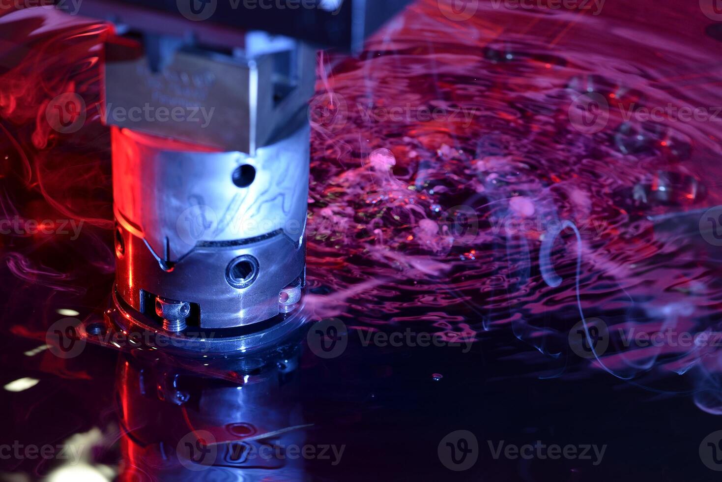 close up view of the machine working on liquid with red and blue illumination photo