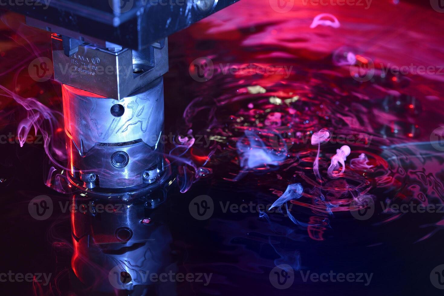 machine working on liquid with blue and red illumination photo