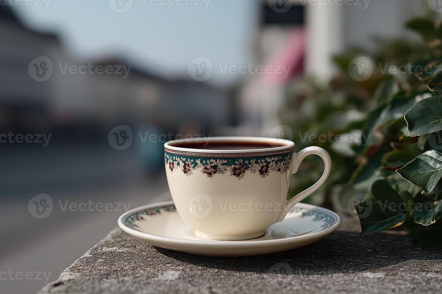 Beautiful coffee cup on a stone ledge with a city background during daylight hours photo