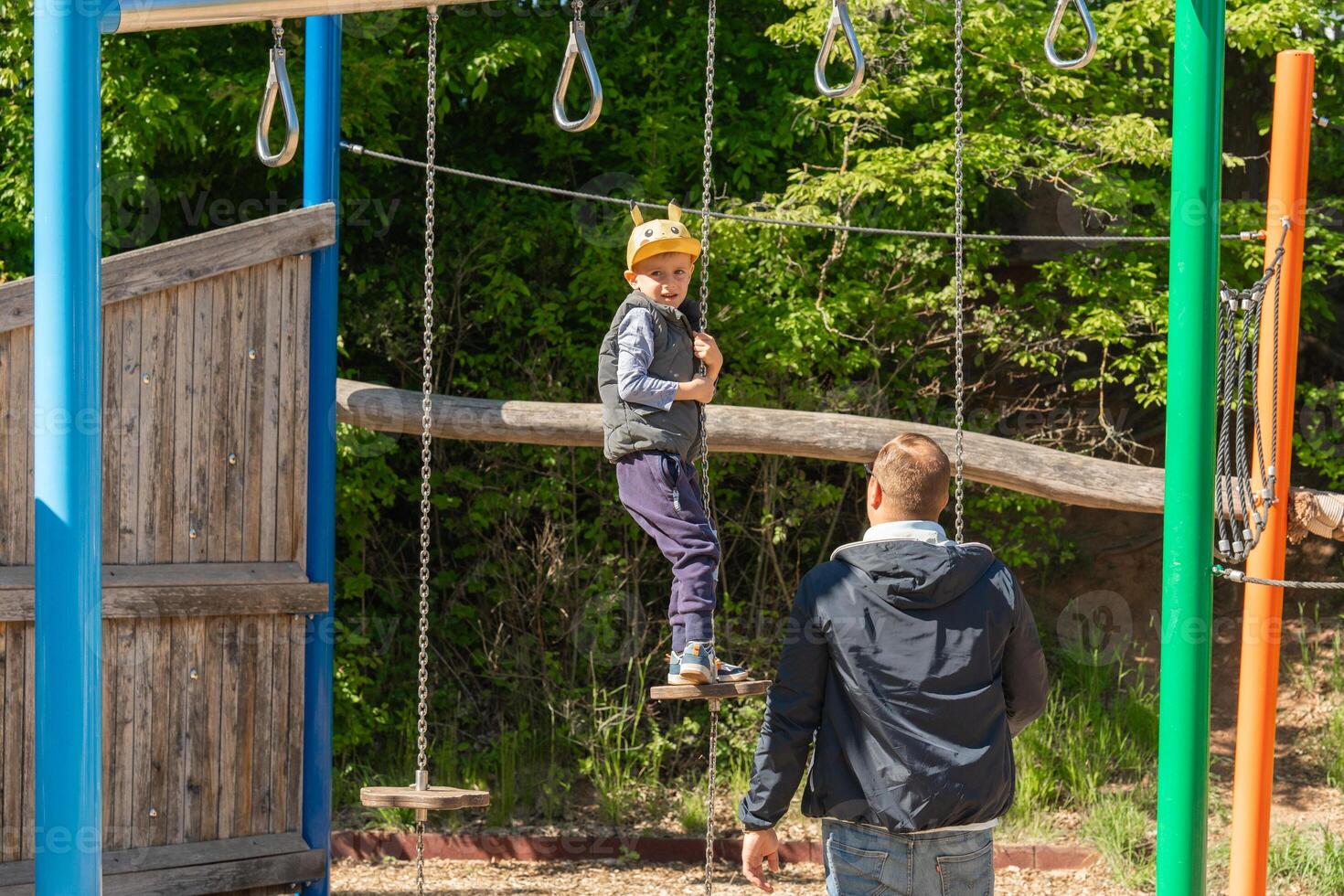 Child Enjoying Playground Adventure with Parental Support photo