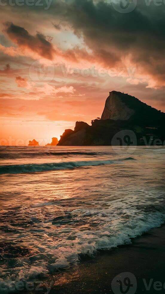 Sunset at the beach with waves and mountains photo