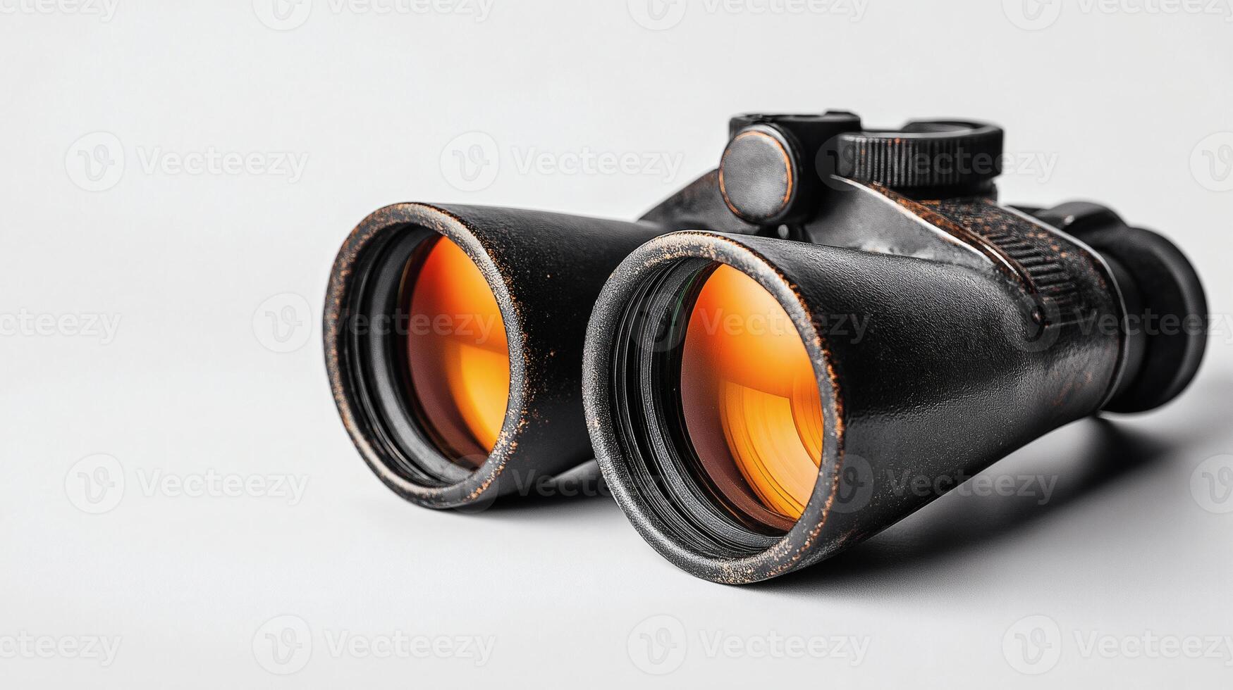 Vintage Black Binoculars with Amber-Tinted Lenses on White Background photo