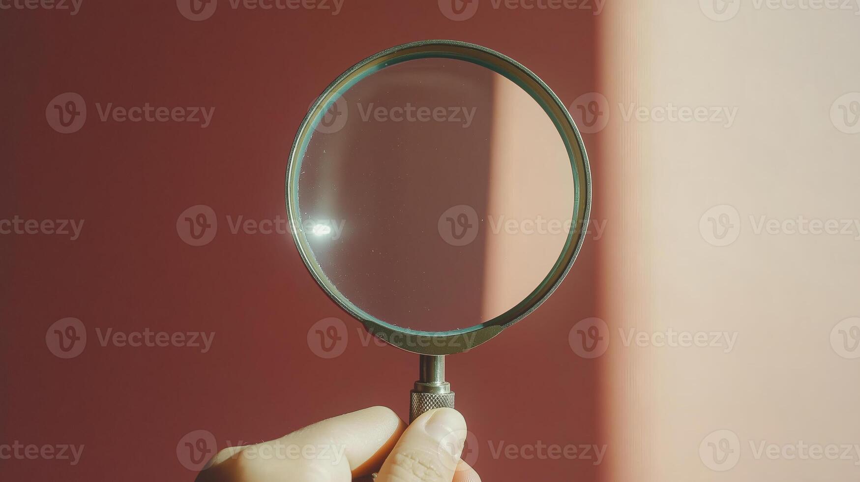 Hand Holding a Magnifying Glass in Sunlight photo