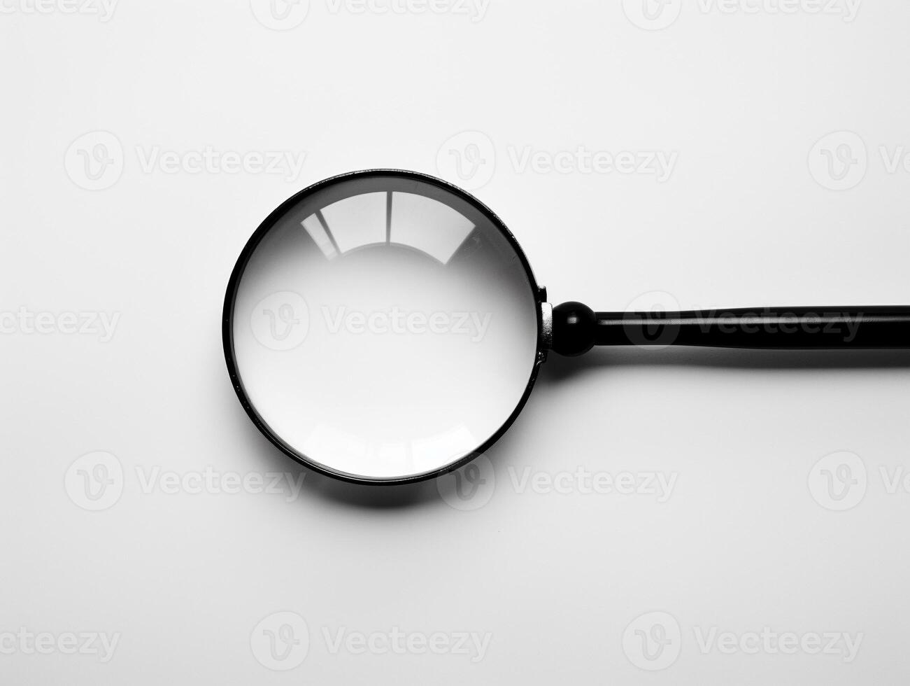 A magnifying glass is shown on a white background photo