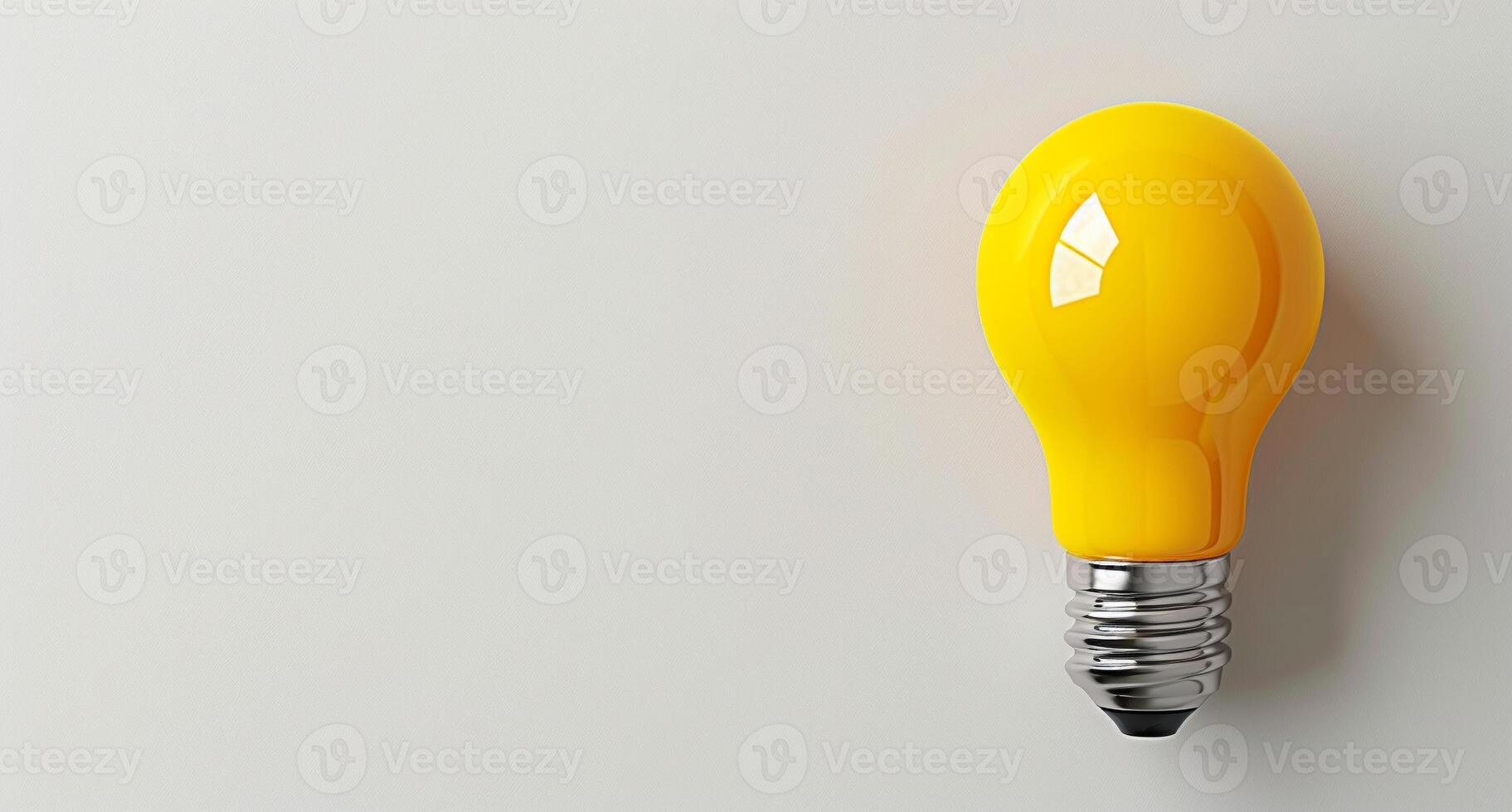 A yellow light bulb is lit up on a white background photo