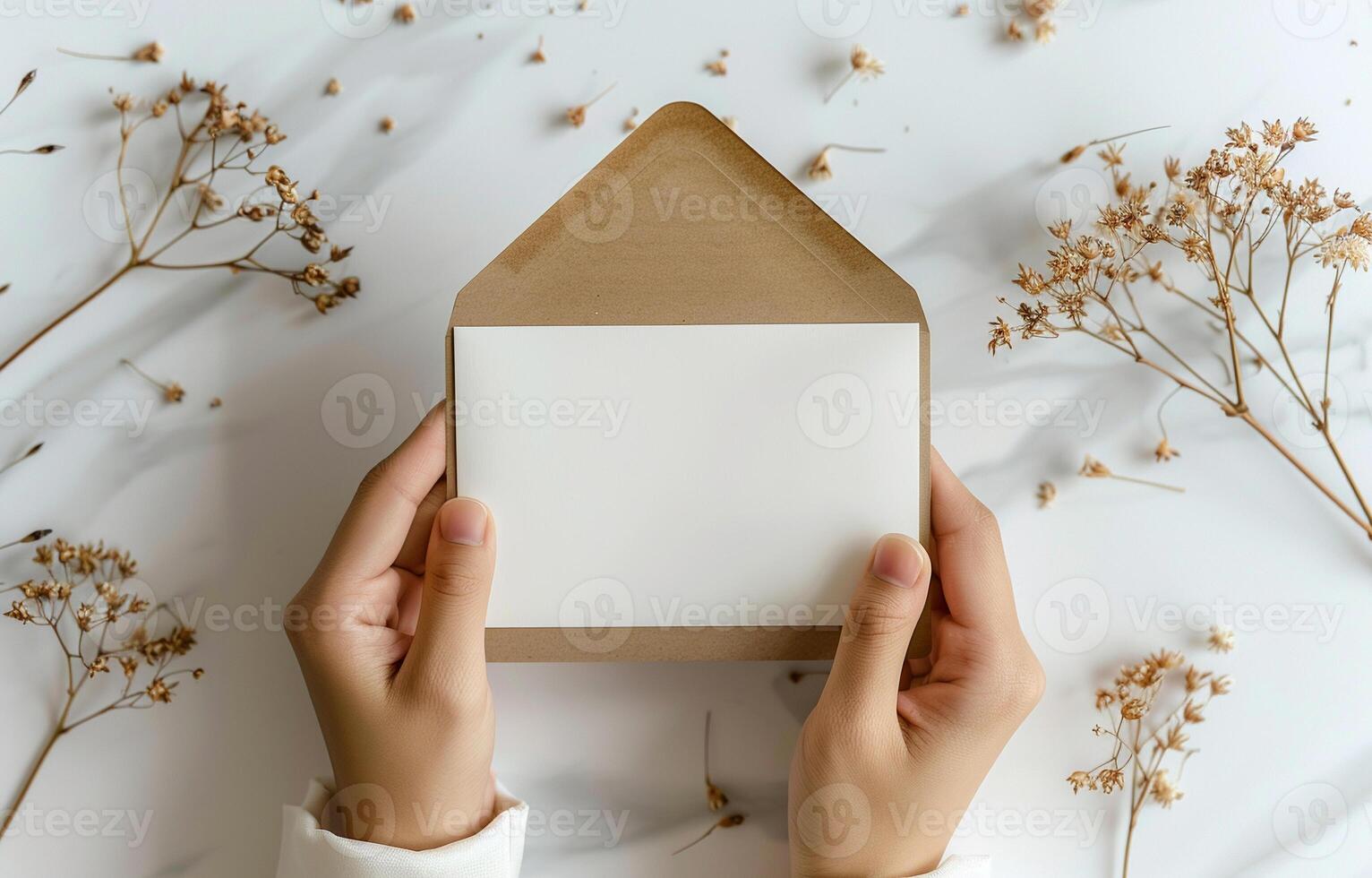 A person holding a white envelope with a brown envelope on top of it and surrounded by flower photo