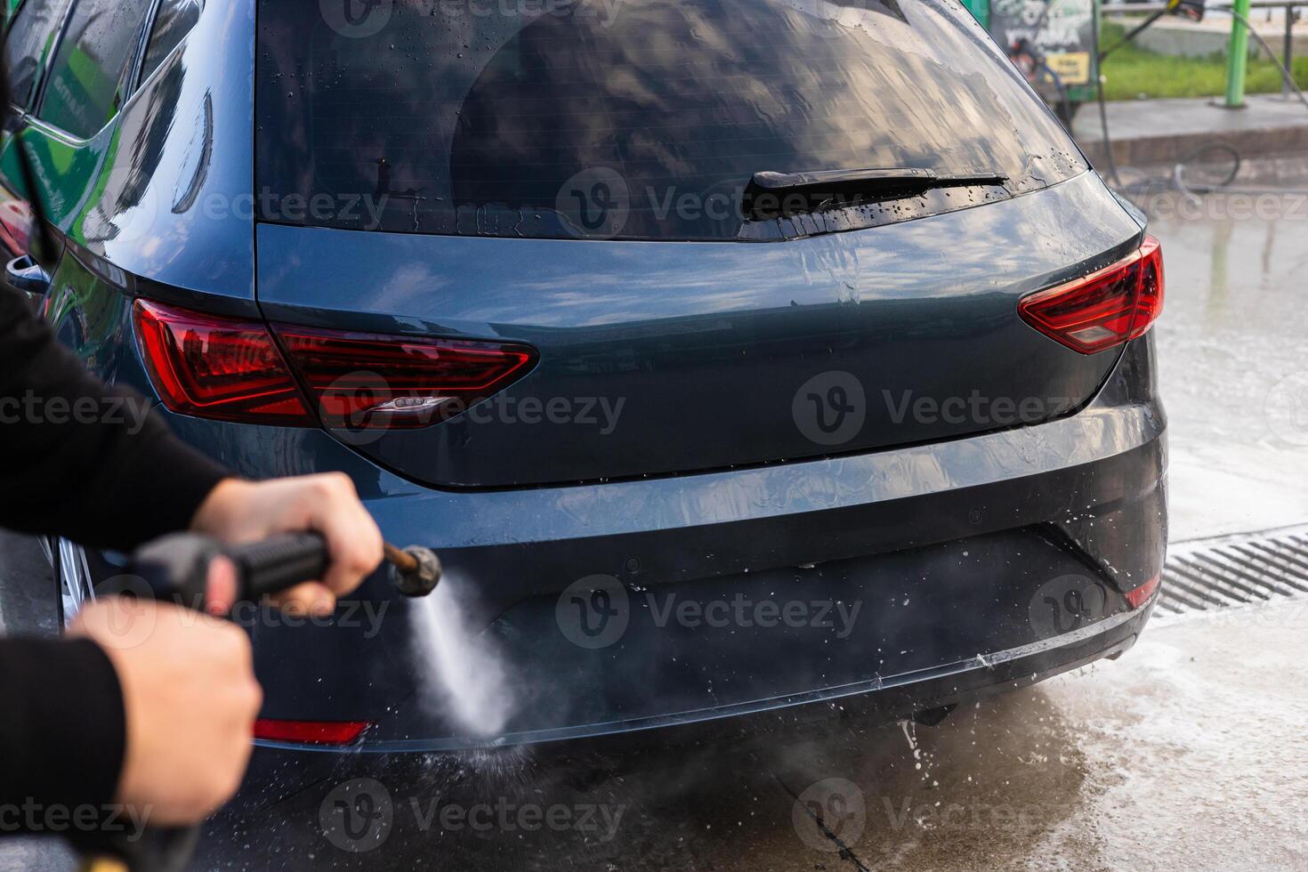 Car wash experience with a foam spray at a local washing station on a sunny day photo