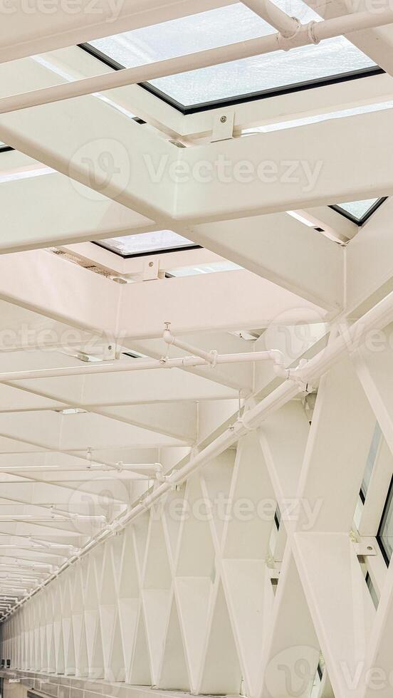 Modern architectural ceiling with geometric patterns and skylights showcases innovative structural design in urban spaces photo