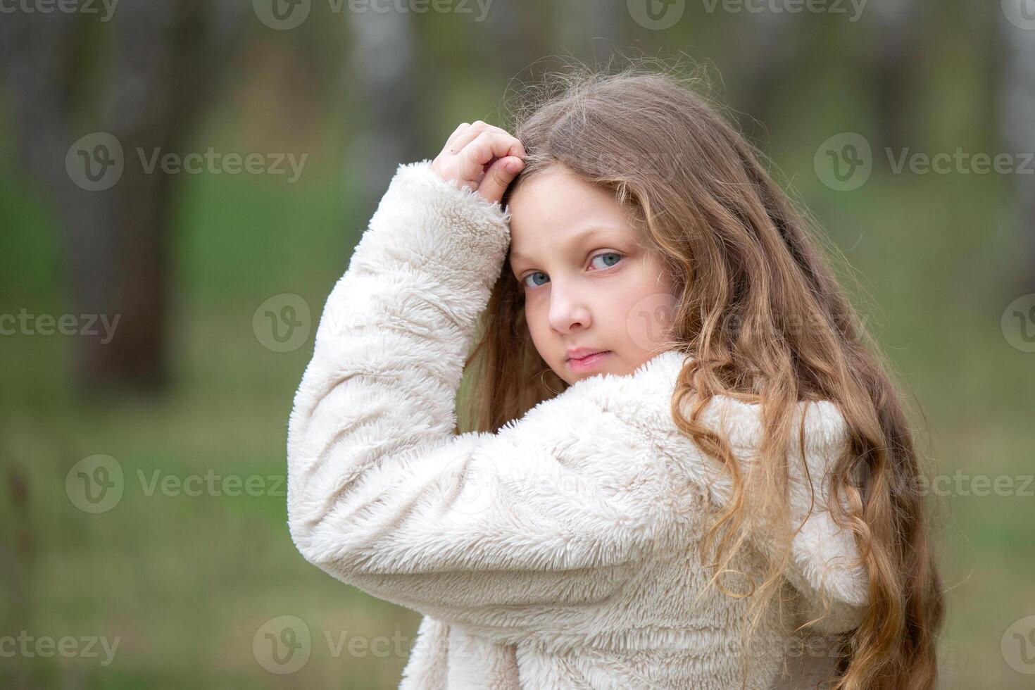 Portrait of a blue-eyed girl with long blond hair photo