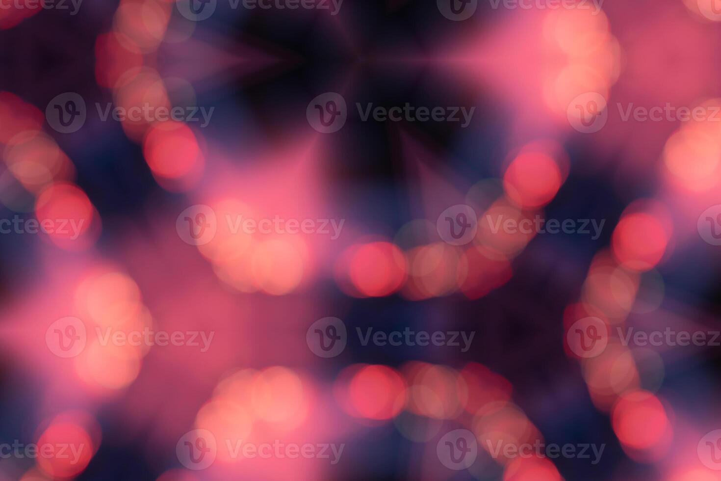 A blurry image of a starry night sky with pink and blue hues. The image is abstract and has a dreamy, ethereal quality to it photo