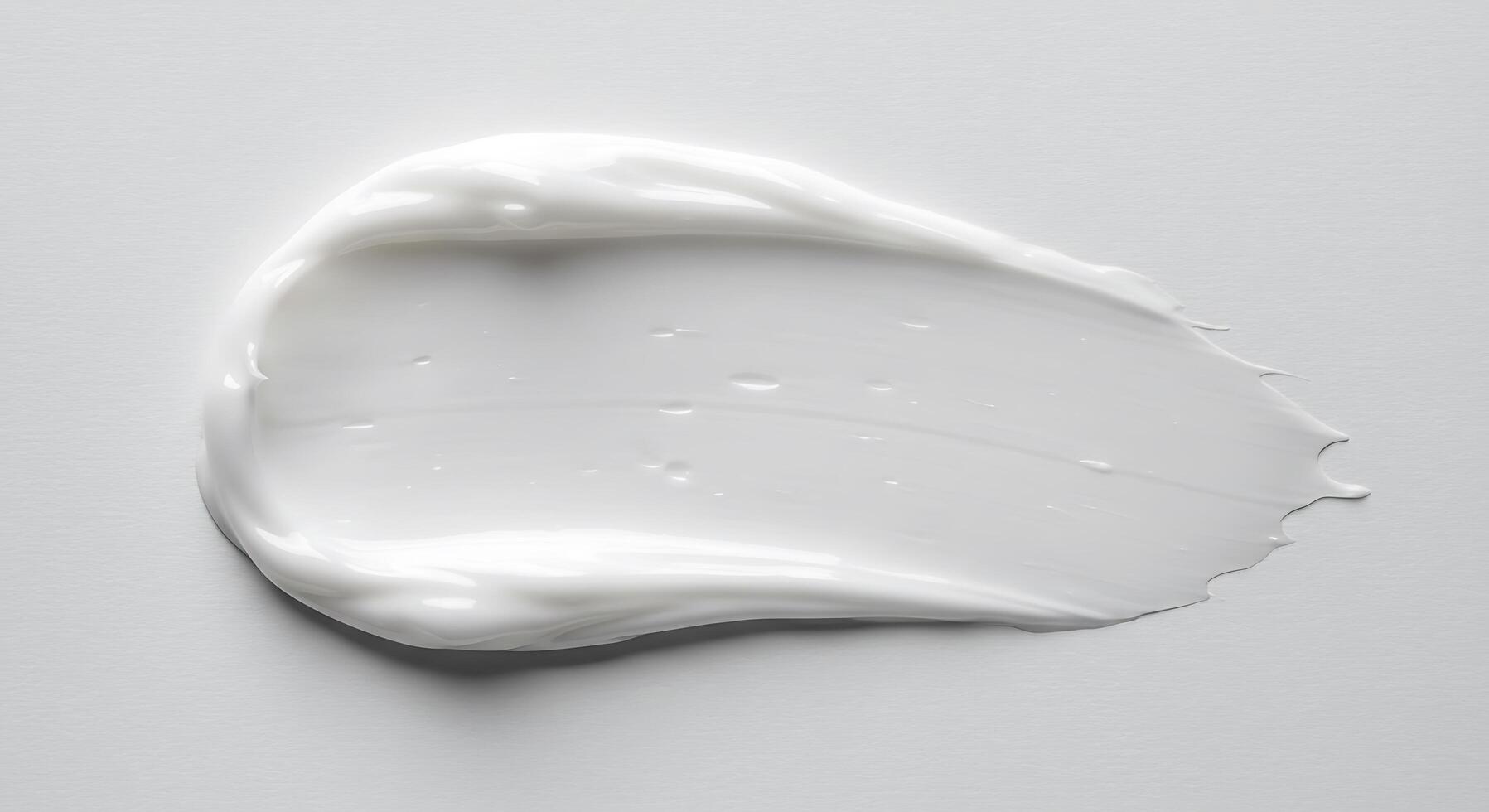 A white liquid is sitting on top of a white surface photo