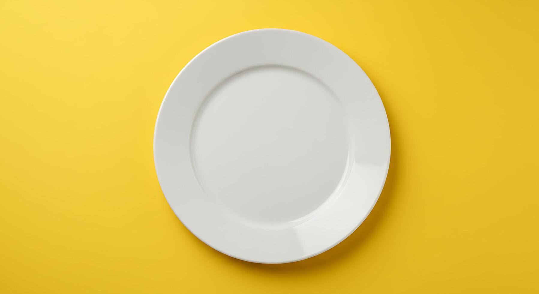 Empty white plate on yellow background photo